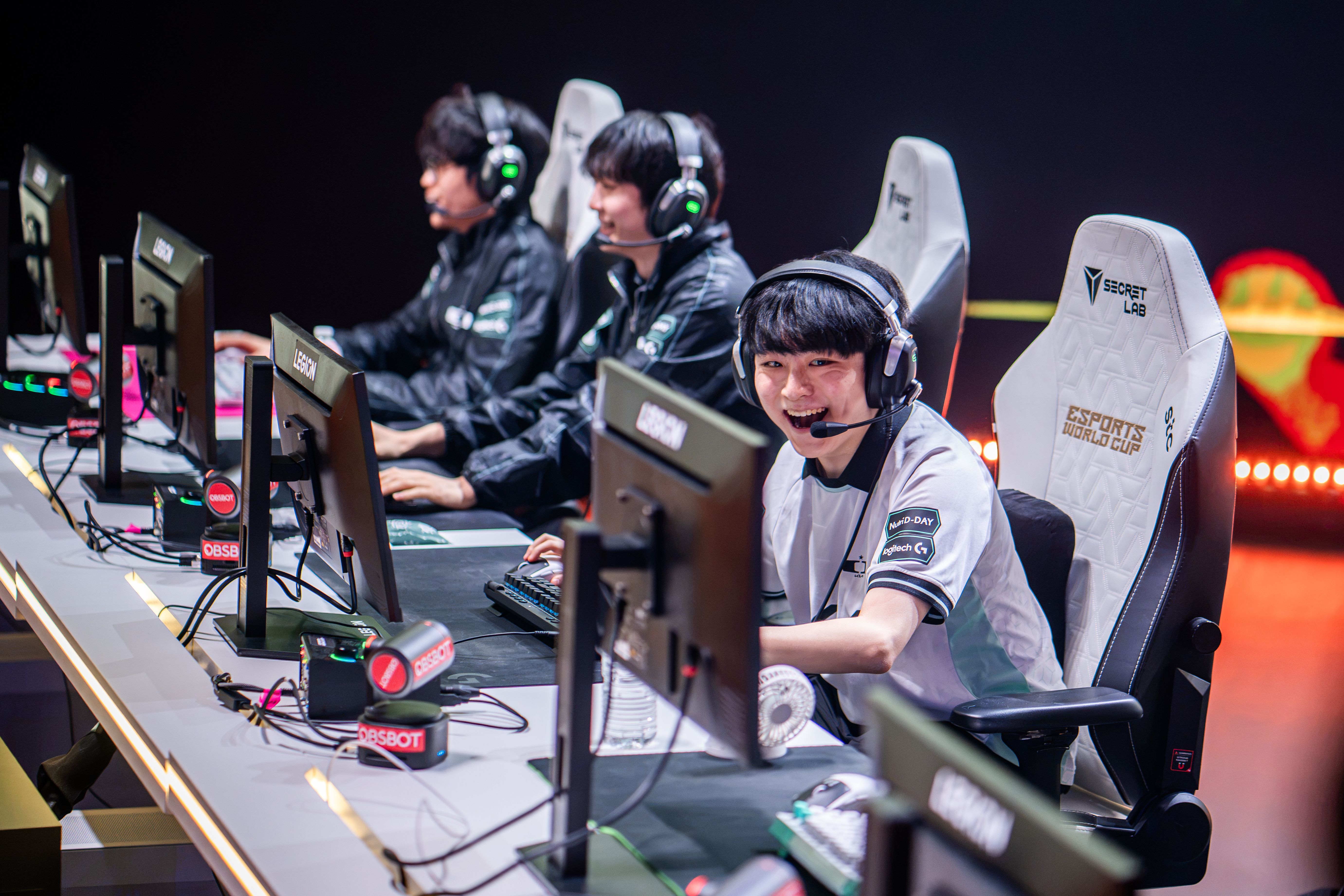 Dplus KIA lifting the Esports World Cup 2026 League of Legends trophy on stage in Paris